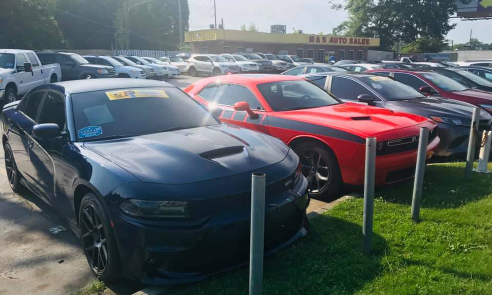 Picture of vehicles for sale outside the offices at M & S Auto Sales.